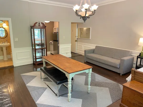 a room with chandelier furniture and wooden floor
