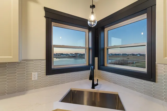 a view of a kitchen with a sink and a window