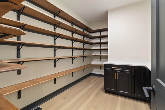 a kitchen with a wooden floor and white walls