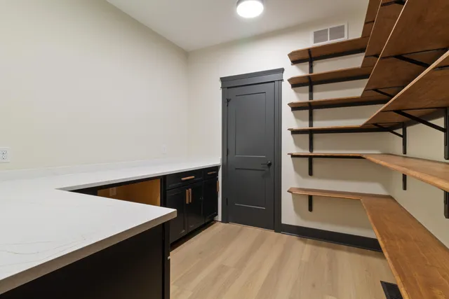 a view of walk in closet with empty racks