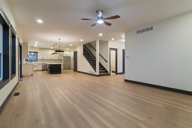 a view of a kitchen with furniture and a ceiling fan