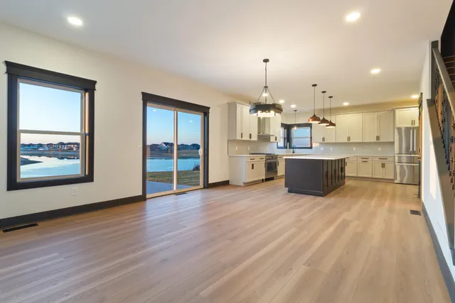 a view of kitchen with furniture and wooden floor