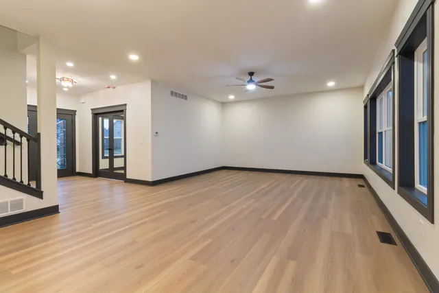a view of an empty room with wooden floor