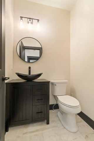 a bathroom with a toilet and a mirror