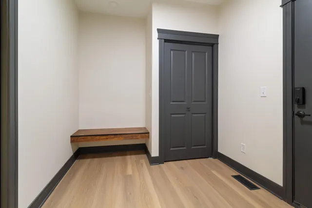 a view of a room with wooden floor and closet
