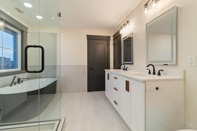a spacious bathroom with a double vanity sink mirror and