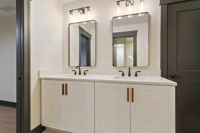 a bathroom with a double vanity sink and a mirror