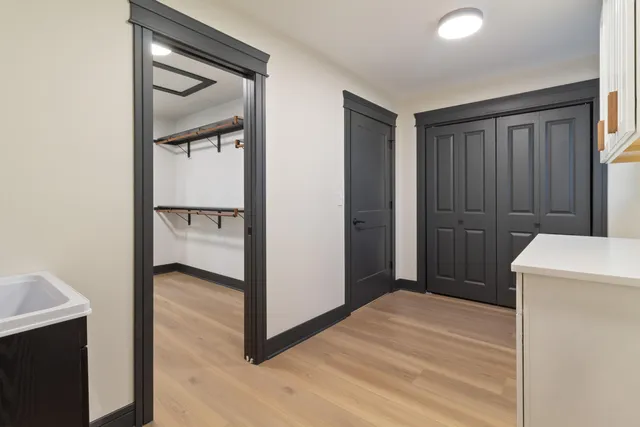 a view of a hallway with wooden floor