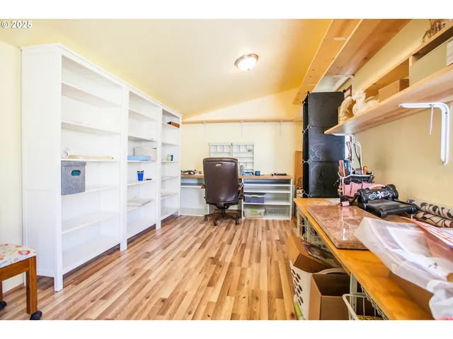 a room with wooden floor and furniture