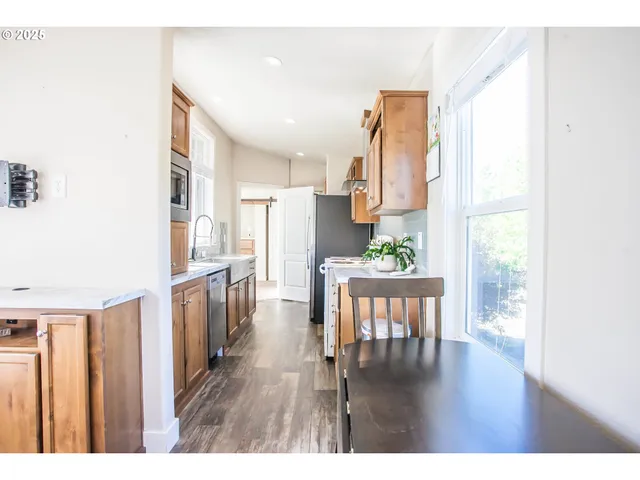 a kitchen with a sink stove and microwave