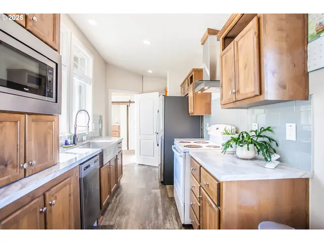 a open kitchen with sink refrigerator and cabinets