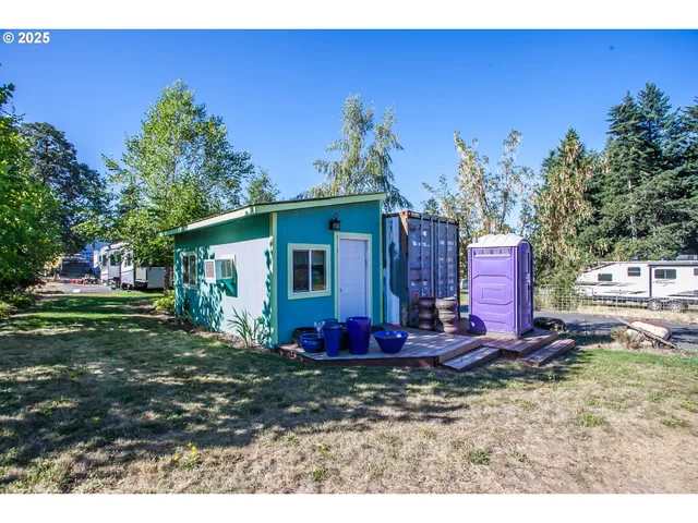 a view of a backyard with wooden fence