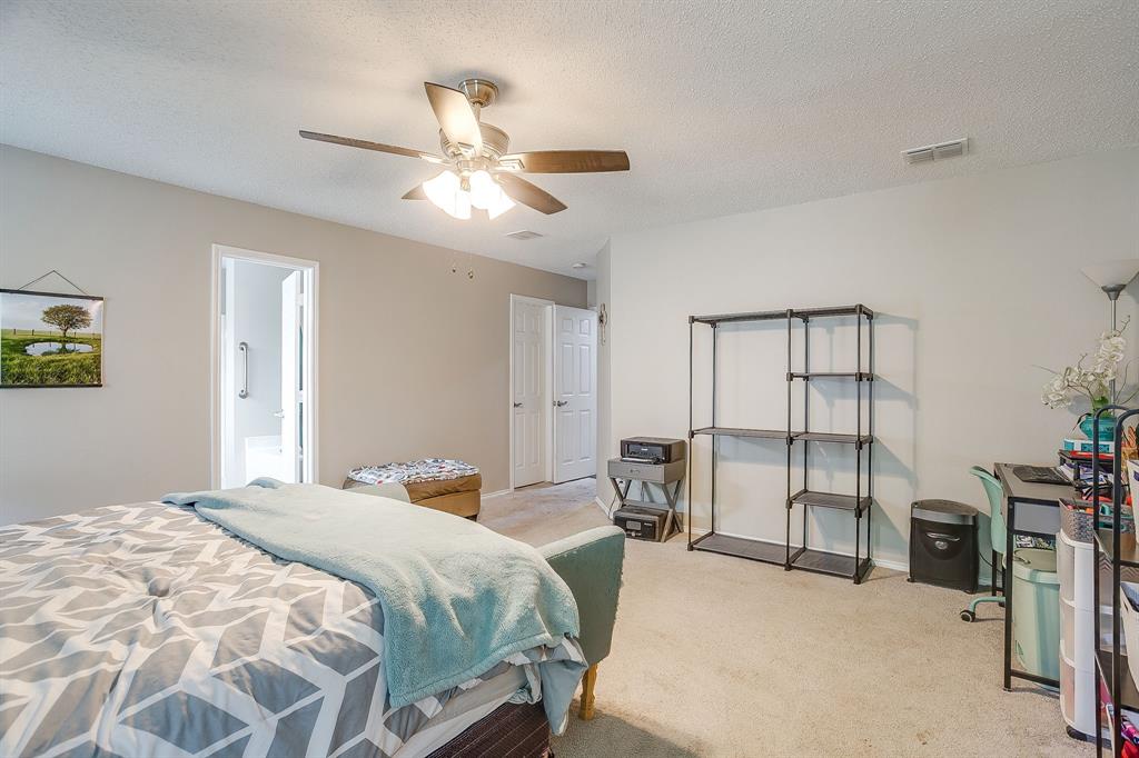 5441 Temecula Road Fort Worth, TX 76244 - Photo 19 of 33 Spacious bedroom featuring neutral wall paint, carpet flooring, a ceiling fan with integrated lighting, and a white interior door