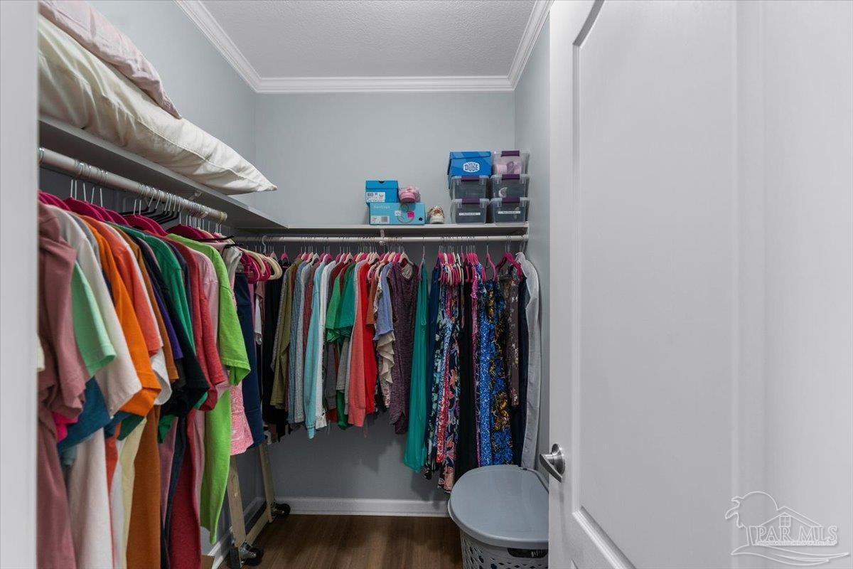 4955 Blue Ribbon Drive Milton, FL 32583 - Photo 14 of 32 a view of walk in closet with clothes and shoes