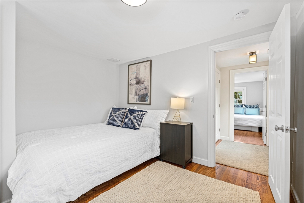 1 Richland Road Wellesley, MA 02481 - Photo 23 of 31 a bedroom with a bed and a lamp