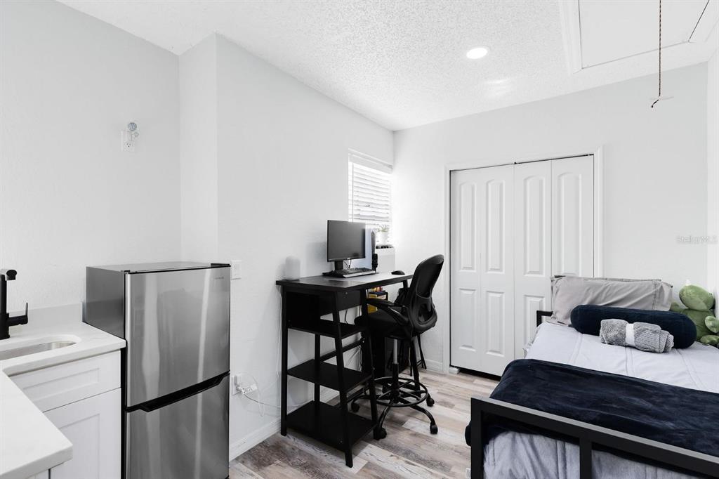 106 Edgewater Drive St. Cloud, FL 34769 - Photo 5 of 18 a bedroom with a bed and a table