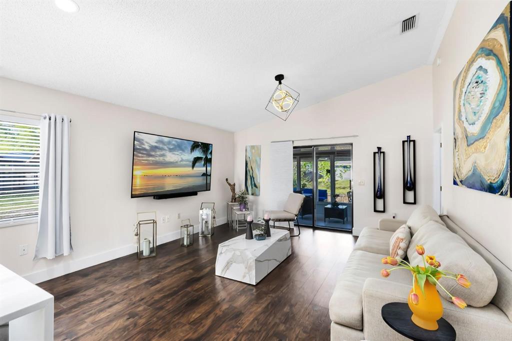 106 Edgewater Drive St. Cloud, FL 34769 - Photo 7 of 18 a living room with furniture and a flat screen tv
