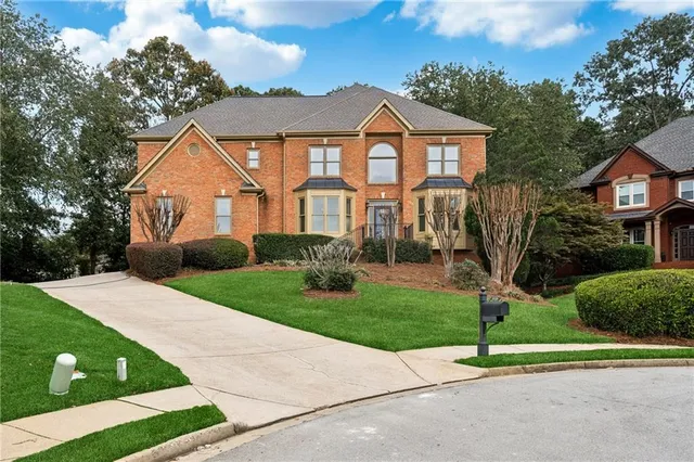 a front view of a house with a yard