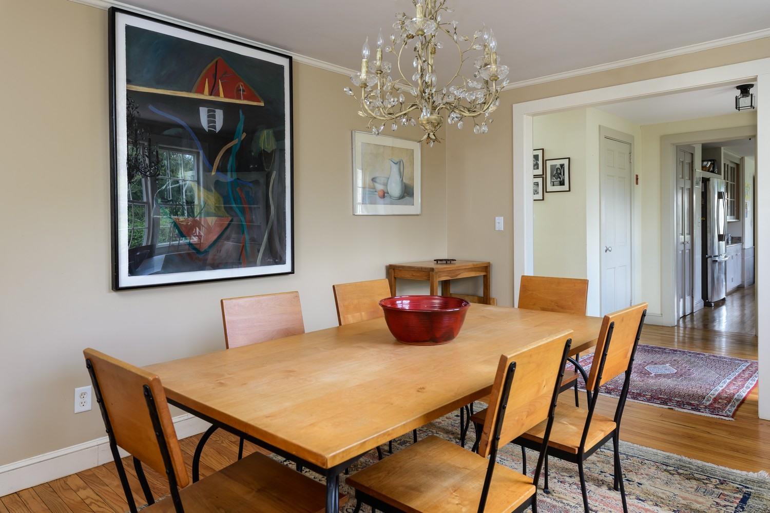 115 Rendezvous Lane Barnstable, MA 02630 - Photo 15 of 34 a view of a dining room with furniture wooden floor and a chandelier