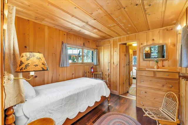 a bedroom with a bed and wooden cabinets