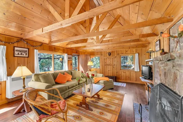 a living room with patio furniture and a fireplace