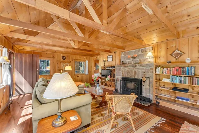 a living room with fireplace furniture and a fireplace