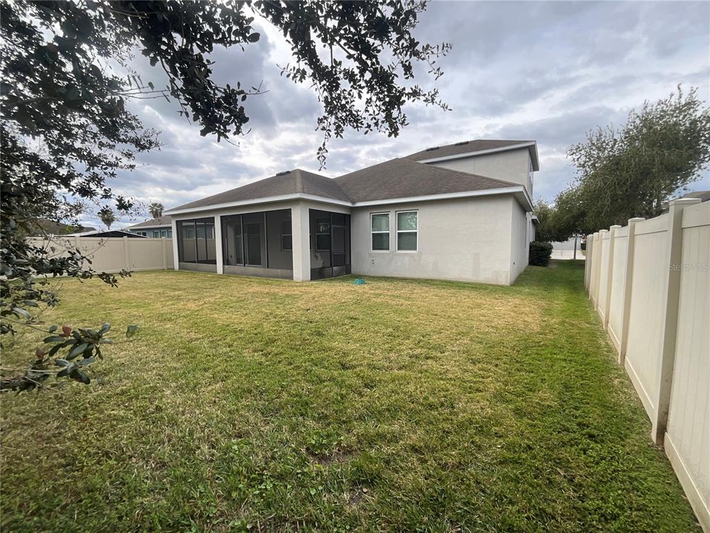 3560 Pixie Lane St. Cloud, FL 34772 - Photo 13 of 74 a view of a house with a yard