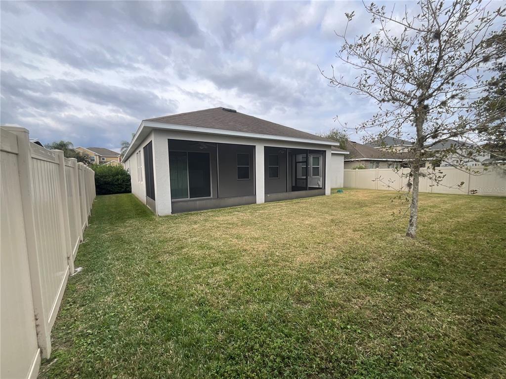 3560 Pixie Lane St. Cloud, FL 34772 - Photo 14 of 74 a view of a house with a yard