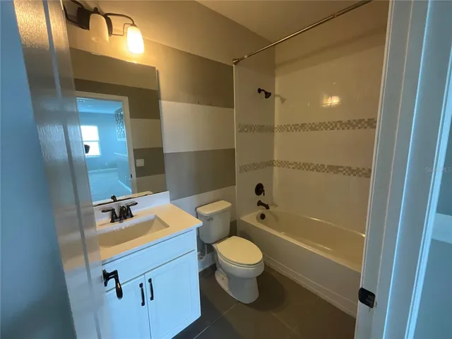 a bathroom with a double vanity sink and mirror