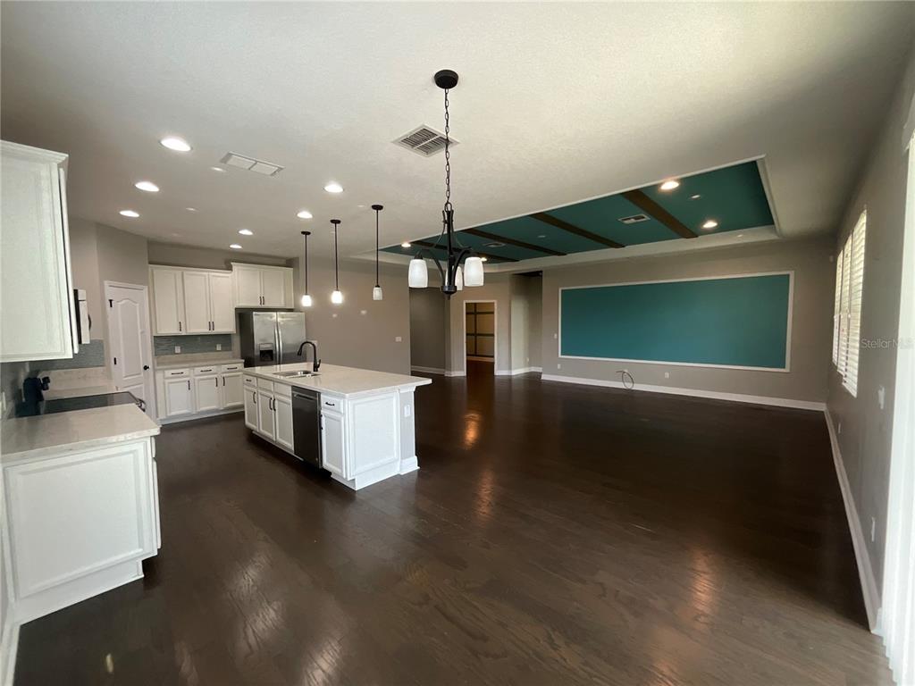 3560 Pixie Lane St. Cloud, FL 34772 - Photo 43 of 74 a open kitchen with white cabinets and stainless steel appliances