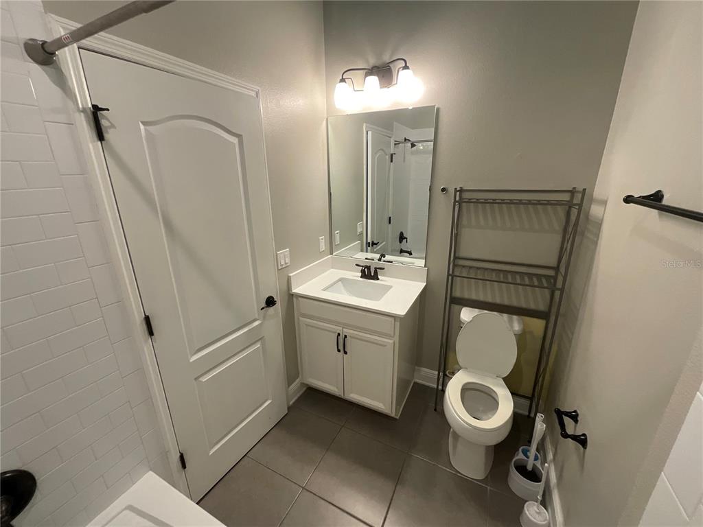3560 Pixie Lane St. Cloud, FL 34772 - Photo 52 of 74 a bathroom with a toilet sink and mirror