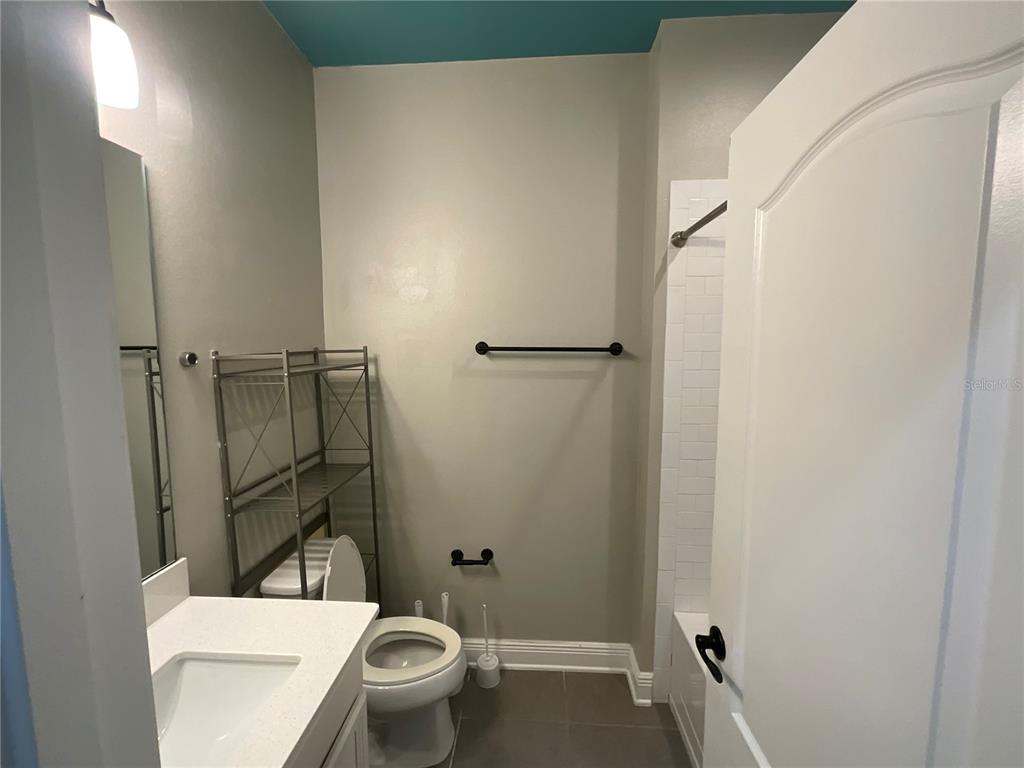 3560 Pixie Lane St. Cloud, FL 34772 - Photo 54 of 74 a white toilet sitting next to a bathroom sink