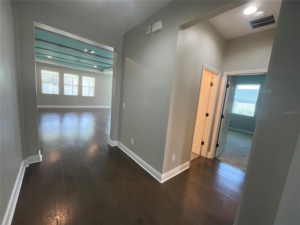 3560 Pixie Lane St. Cloud, FL 34772 - Photo 57 of 74 an empty room with wooden floor and windows