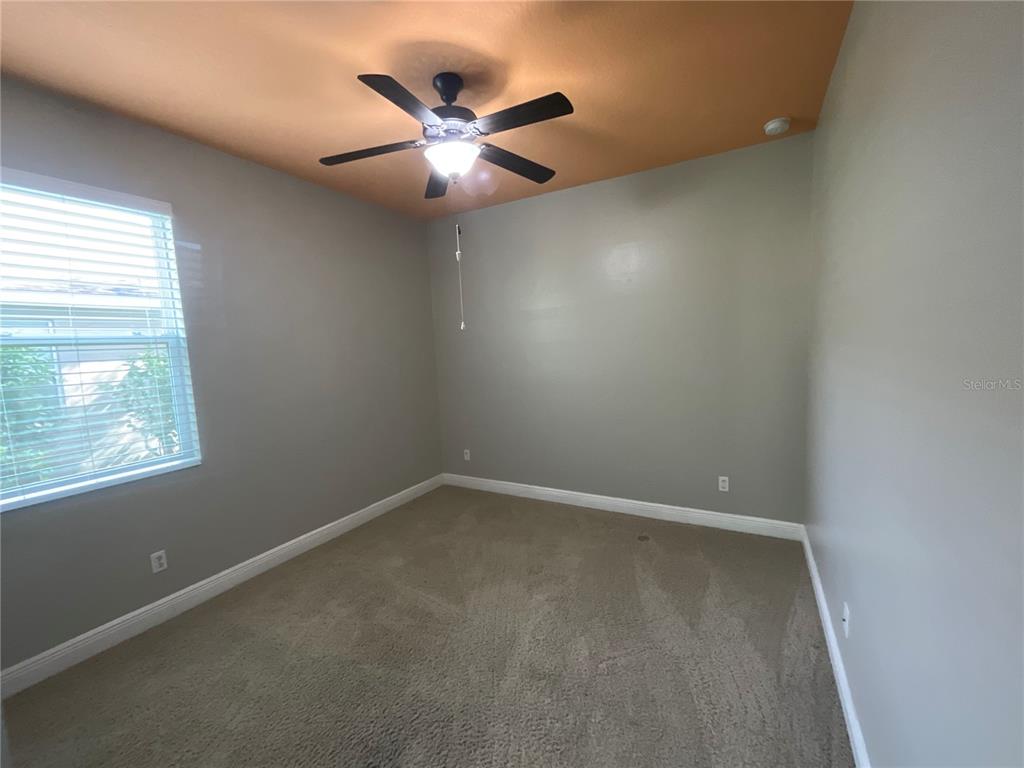 3560 Pixie Lane St. Cloud, FL 34772 - Photo 59 of 74 an empty room with a window and a fan