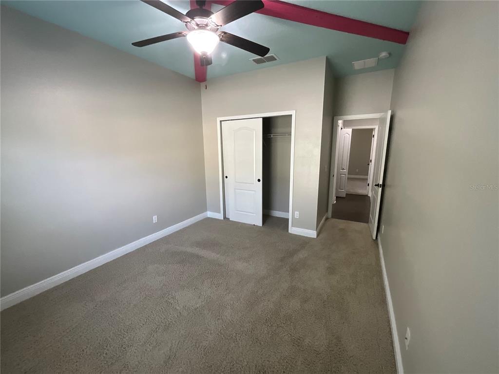 3560 Pixie Lane St. Cloud, FL 34772 - Photo 62 of 74 an empty room with closet and a chandelier fan