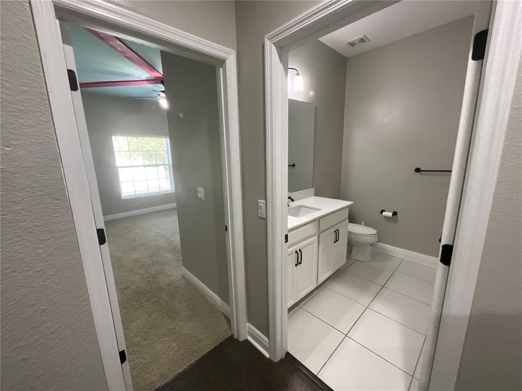 3560 Pixie Lane St. Cloud, FL 34772 - Photo 64 of 74 a bathroom with a toilet sink and mirror