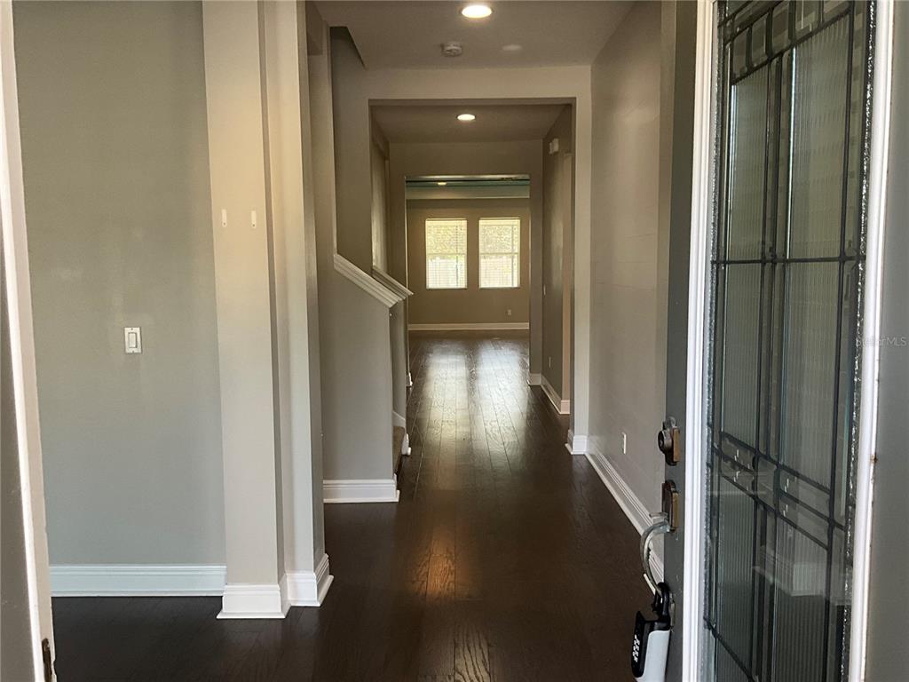 3560 Pixie Lane St. Cloud, FL 34772 - Photo 70 of 74 a view of a hallway with wooden floor