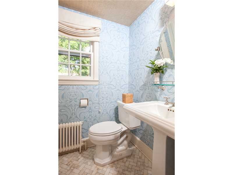 15 Abbey Road Darien, CT 06820 - Photo 8 of 18 a white toilet sitting next to a bathroom sink