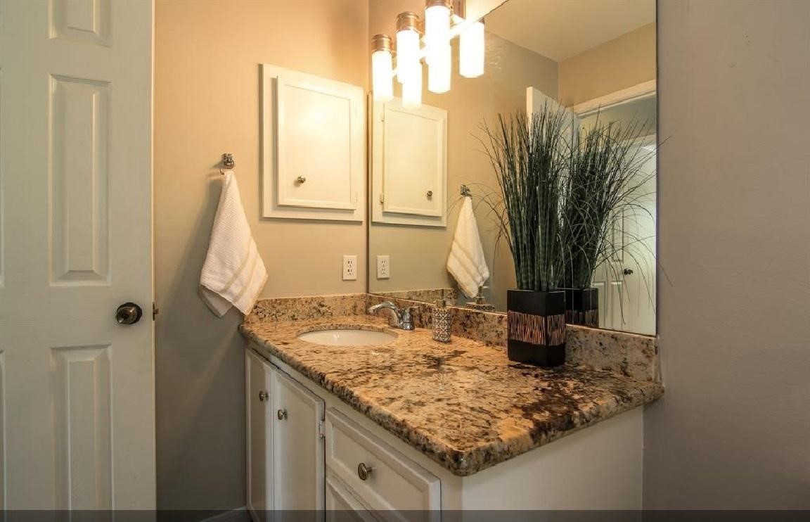 11423 Wickersham Lane Houston, TX 77077 - Photo 20 of 39 a bathroom with a granite countertop sink and a mirror