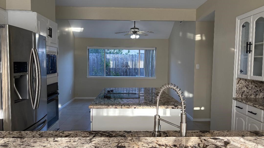 11423 Wickersham Lane Houston, TX 77077 - Photo 8 of 39 a kitchen with stainless steel appliances kitchen island granite countertop a refrigerator and a stove top oven