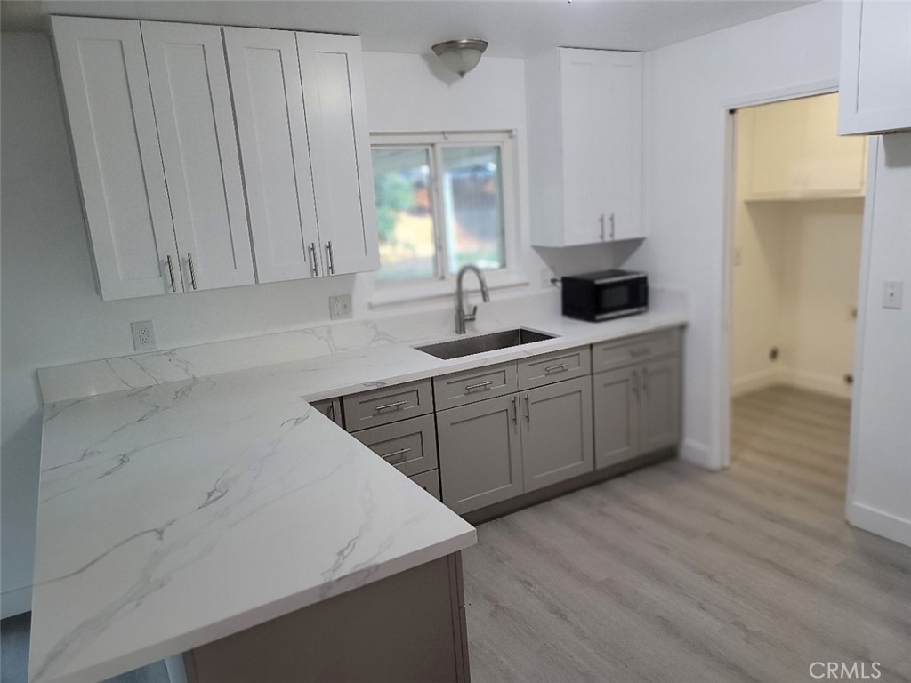 6984 Center Street Highland, CA 92346 - Photo 11 of 24 a kitchen with a sink and cabinets