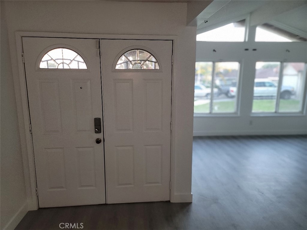 6984 Center Street Highland, CA 92346 - Photo 12 of 24 an empty room with wooden floor fan and windows