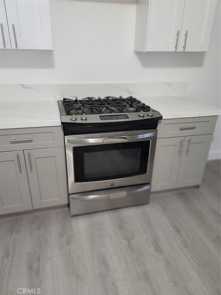 6984 Center Street Highland, CA 92346 - Photo 16 of 24 a stove top oven sitting inside of a kitchen