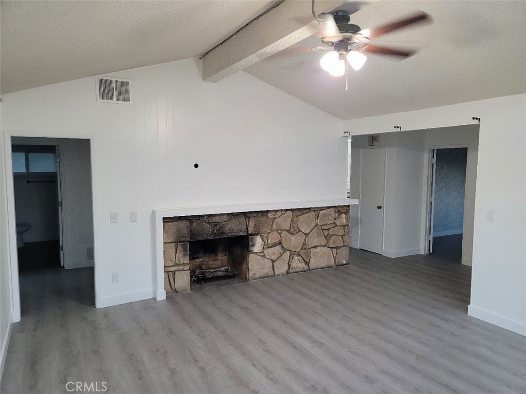 6984 Center Street Highland, CA 92346 - Photo 18 of 24 wooden floor in an empty room with a fireplace