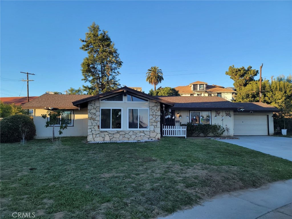 6984 Center Street Highland, CA 92346 - Photo 24 of 24 a view of a house with a yard and a garden