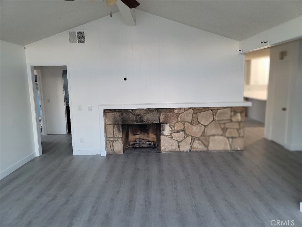 6984 Center Street Highland, CA 92346 - Photo 3 of 24 a view of empty room with wooden floor and fireplace