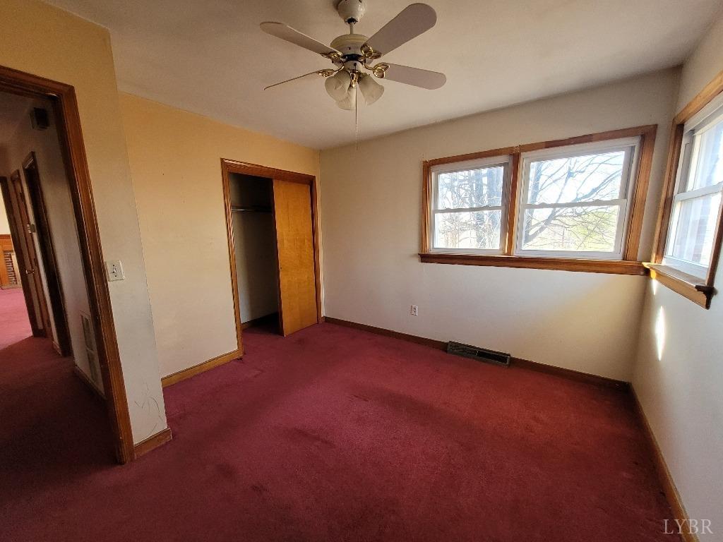1025 Country Club Road Hurt, VA 24563 - Photo 13 of 15 an empty room with windows and fan