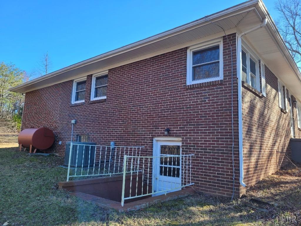 1025 Country Club Road Hurt, VA 24563 - Photo 4 of 15 a view of a brick house with a yard