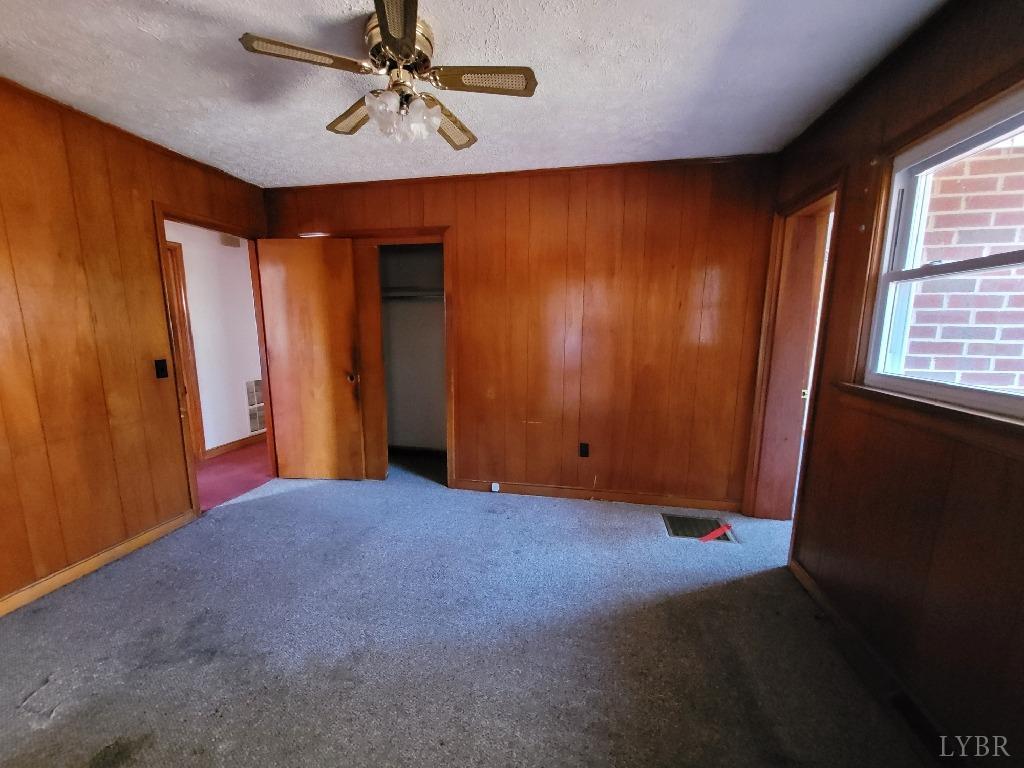 1025 Country Club Road Hurt, VA 24563 - Photo 8 of 15 an empty room with windows and fan
