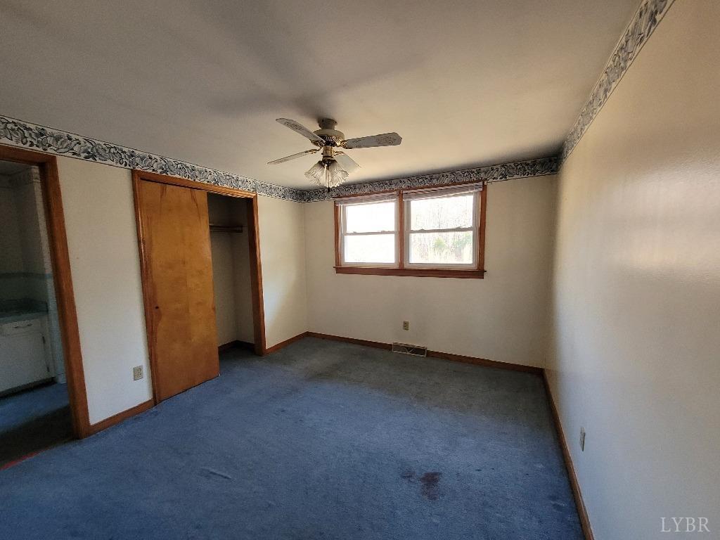 1025 Country Club Road Hurt, VA 24563 - Photo 9 of 15 an empty room with windows and closet